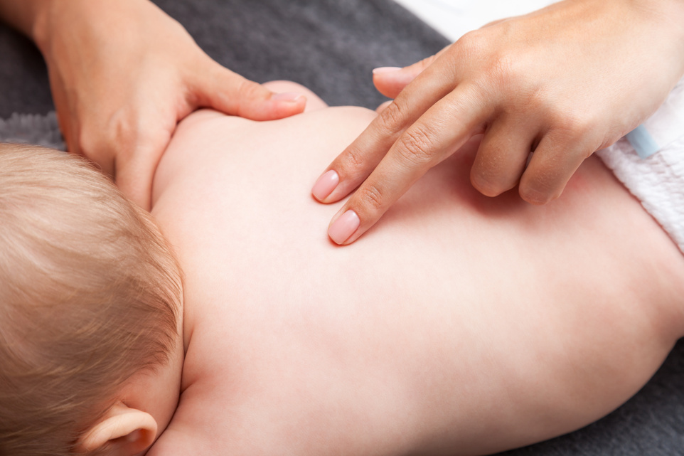 Baby Receiving Chiropractic Treatment on the Back